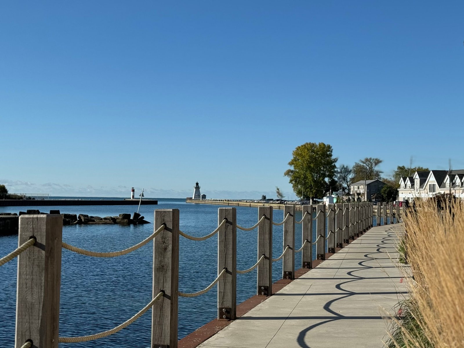 The rope-railed waterfront promenade at Port Dover harbour looking toward the lighthouse and town